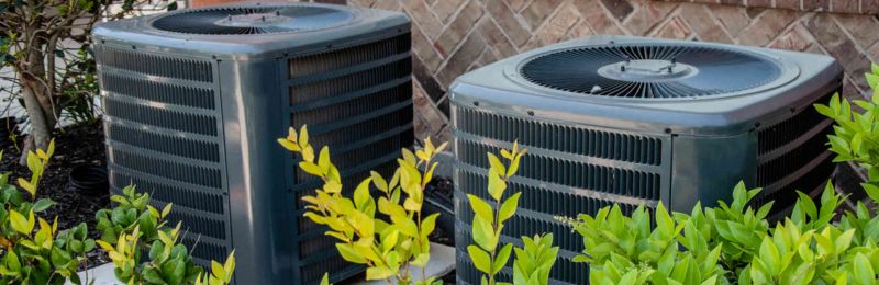 Professional HVAC technician performing air conditioning system maintenance